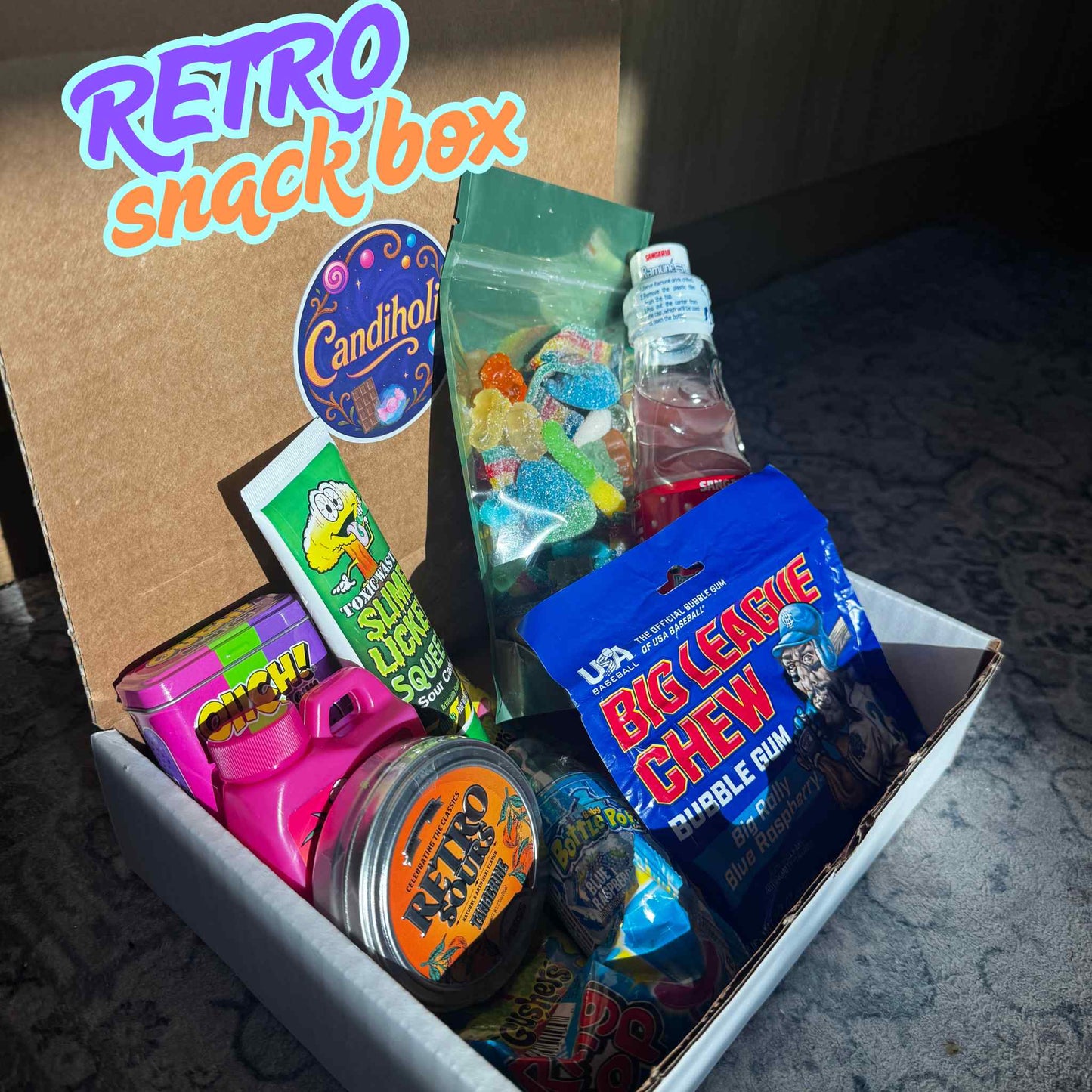 Retro snack box with vintage candy and snacks on a textured surface
