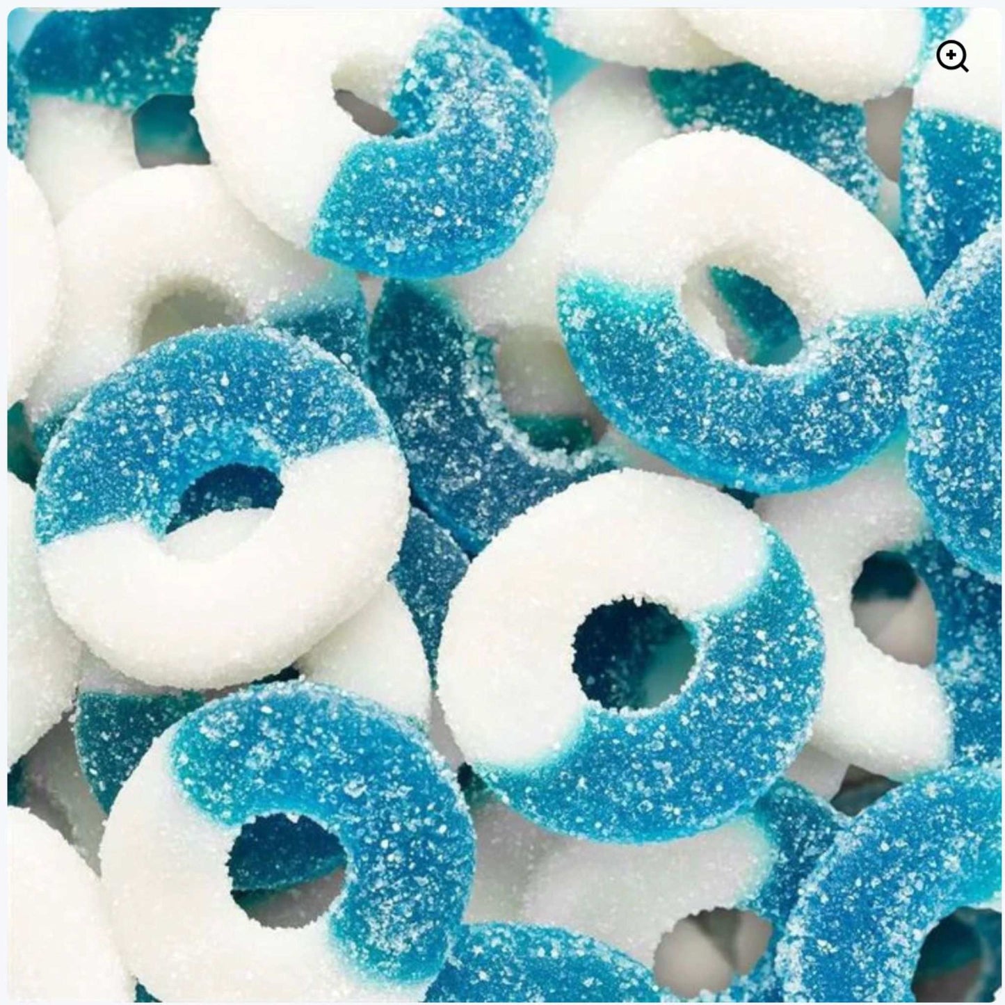 Close-up of blue raspberry gummy rings with white and blue halves, sugar coating, and chewy texture
