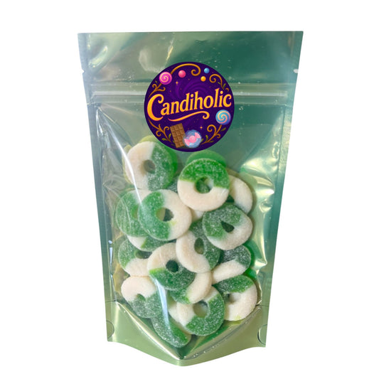 Close-up of sugar-coated green apple gummy rings, half white and half green, with a chewy texture and sour-sweet flavor