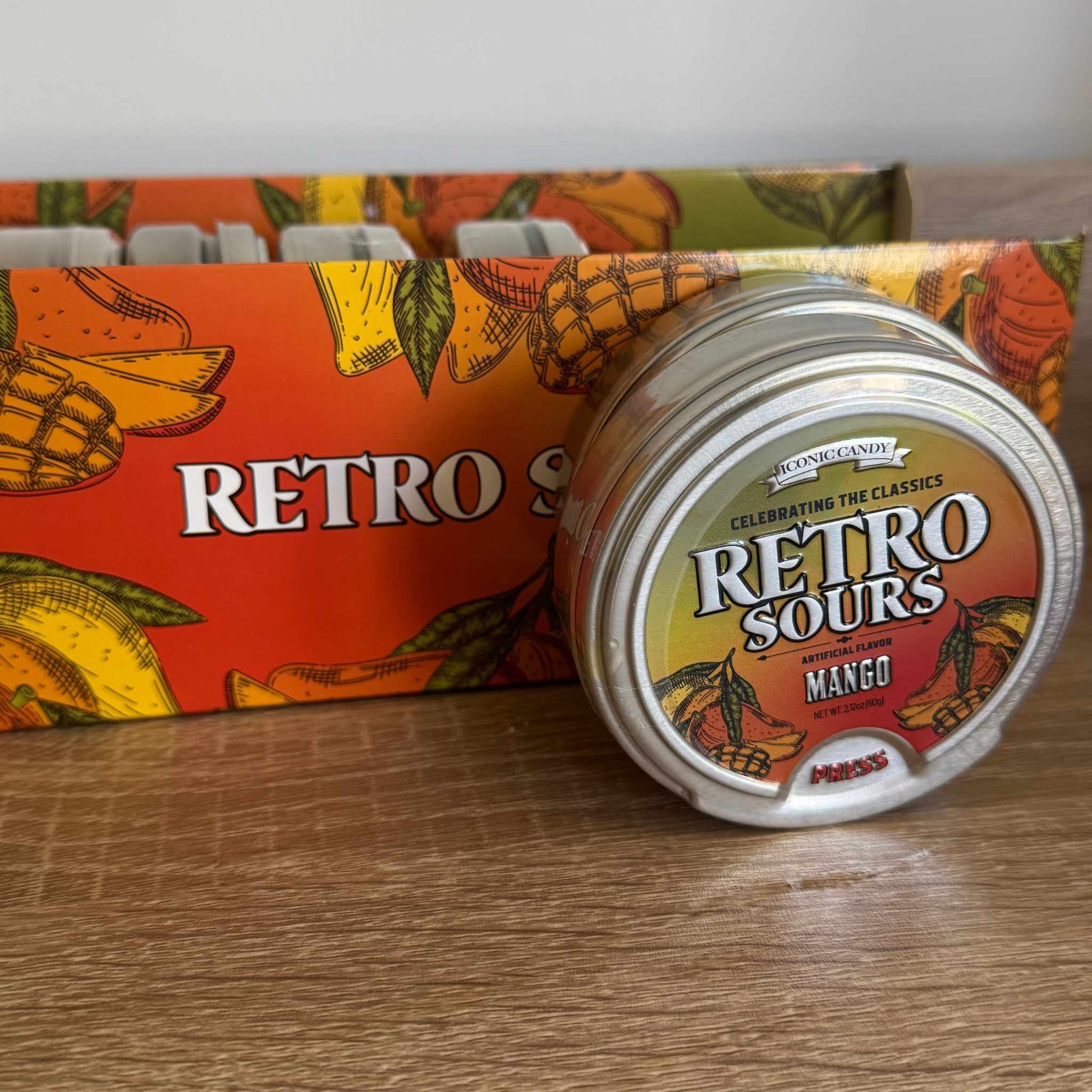 Fun mango sour candy tin with palm tree tropical background